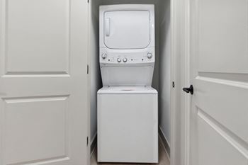 A washer and dryer in a small laundry room